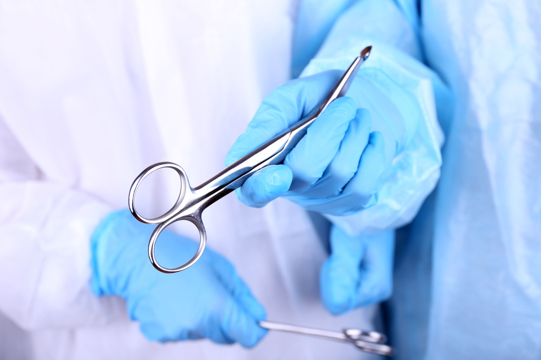 Surgeons Holding Surgical Instruments
